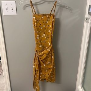Spaghetti strap yellow dress with blue and white flowers.